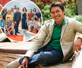 Smiling man seated outdoors with inset of a group of people, likely contestants, posing together on a colorful platform.