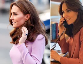 Kate Middleton wearing a pink outfit, not wearing her engagement ring, holding a phone and talking.