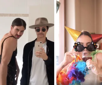 Men posing in front of a mirror, one in a dress, another in a hat; woman wearing party hat, glasses, and sipping wine.