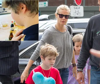 Gwyneth Paltrow walking with two children, one holding a blue heart, and an inset of a child cooking.