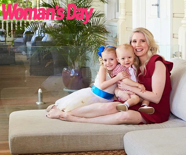 A woman and two children sit on a couch, smiling at the camera, with "Woman's Day" logo in the corner.