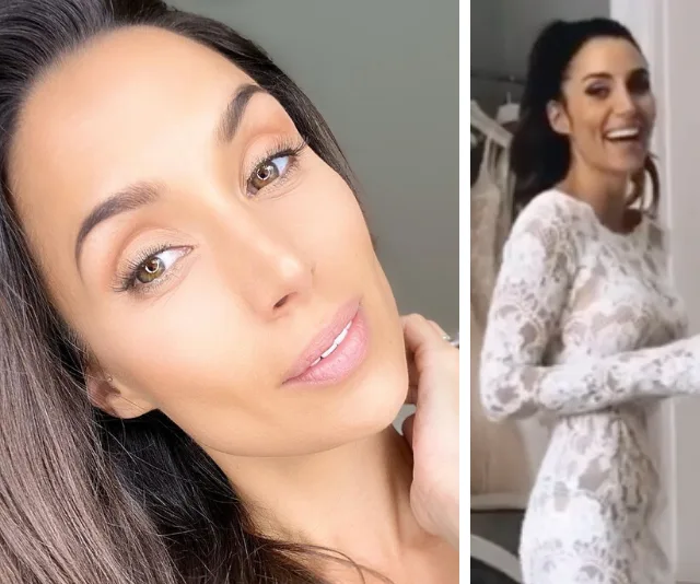 Snezana Wood in a white lace long-sleeve wedding dress, smiling and posing for the camera.