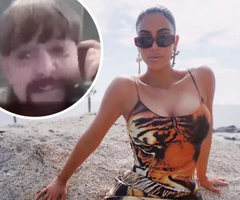 Woman in sunglasses and tiger print dress sits on rock; inset shows a person with a mustache in a video call.