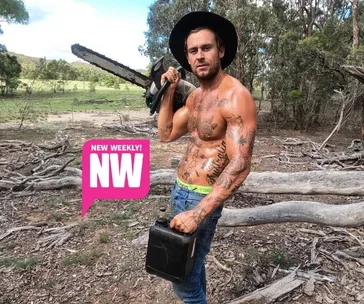 Shirtless man with tattoos and hat holding a chainsaw and fuel can, with "New Weekly! NW" text. Forest setting.