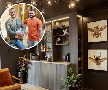 Living room bar with shelves, decor, and art; inset shows two men smiling during renovation.