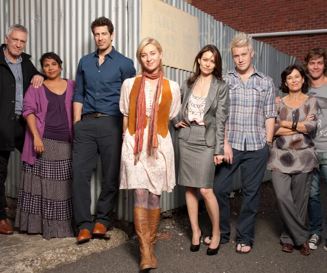 The main cast of "Offspring" poses together outdoors in casual and formal clothing.