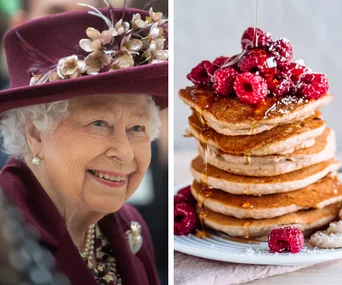 A smiling elderly woman in a hat beside a stack of pancakes topped with raspberries and syrup.