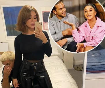 A woman takes a mirror selfie in a bedroom; inset shows a past TV scene with the same woman in conversation.