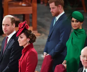 Royal family members attending a formal event, dressed in elegant attire, with focused expressions.