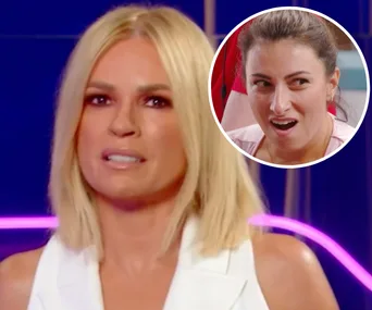 ```html
Alt text: "Woman with blonde hair speaks on camera; inset of another woman reacting."
```