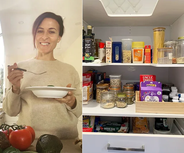 Person smiling with a plate, standing near fresh produce; pantry shelves stocked with jars and packaged goods.