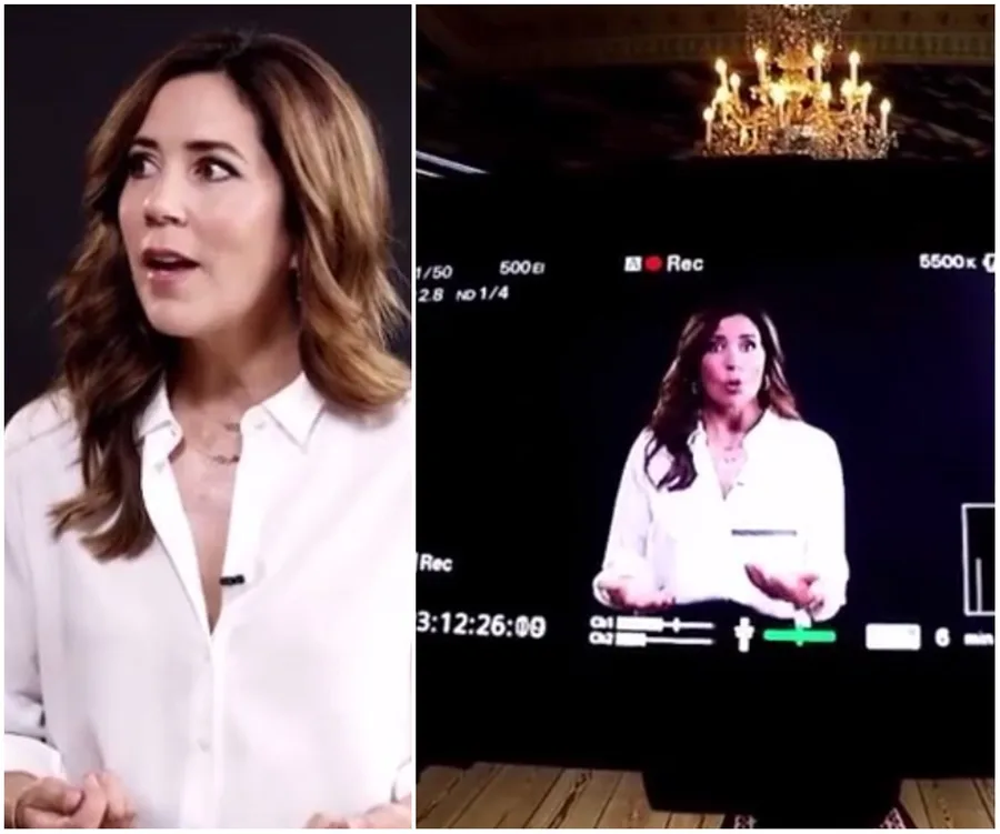"Princess Mary in a white blouse speaking on camera, with studio lights and video screen in the background."