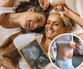 Two smiling individuals on a bed, one holding a baby ultrasound image; inset shows a pregnant belly.
