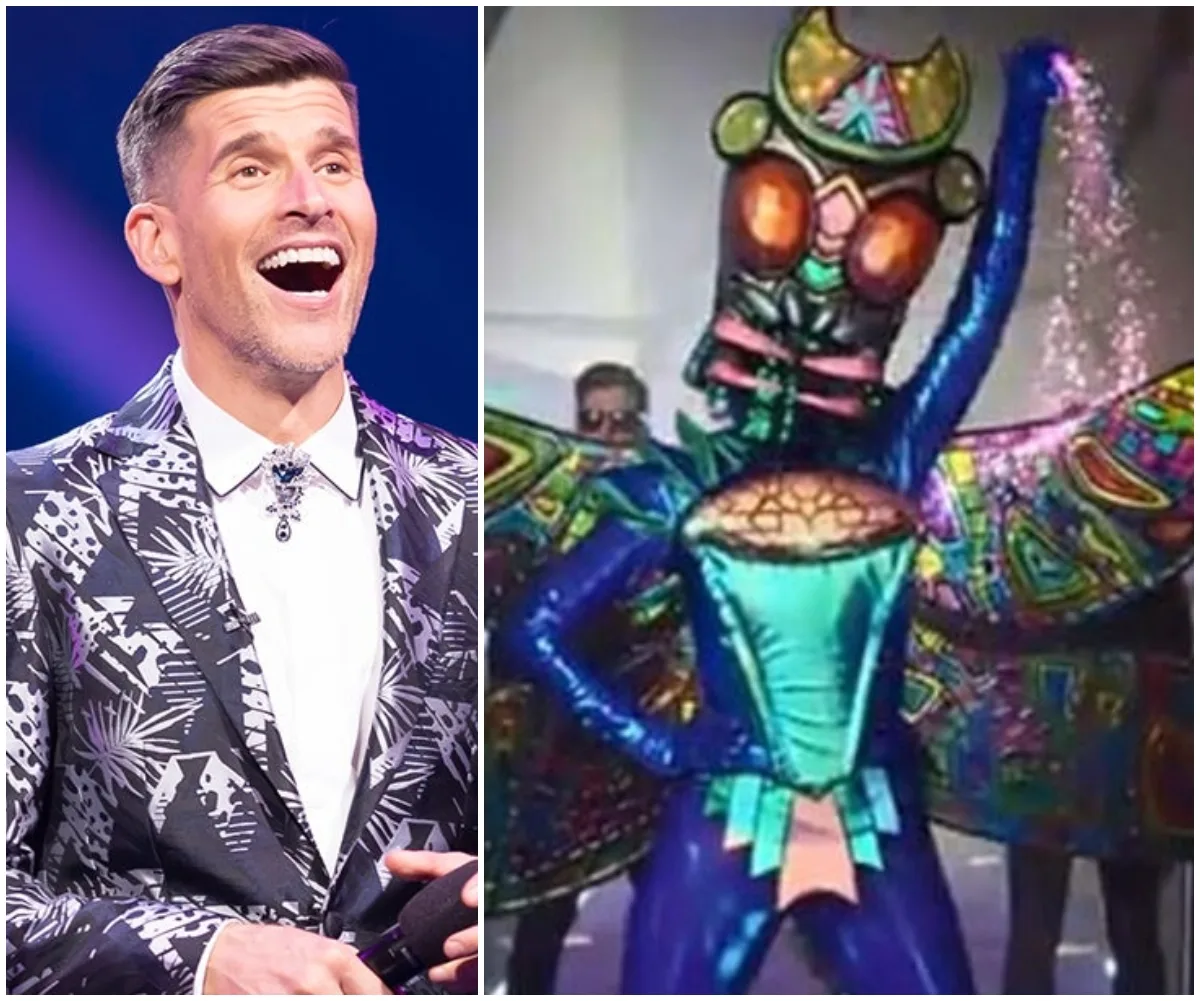 Host in a patterned suit laughing next to a Colorful Moth costume on "The Masked Singer Australia" set.