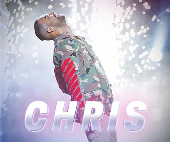 Contestant performing on stage with lights and sparks, wearing a camouflage jacket, with the name "Chris" in bold letters below.
