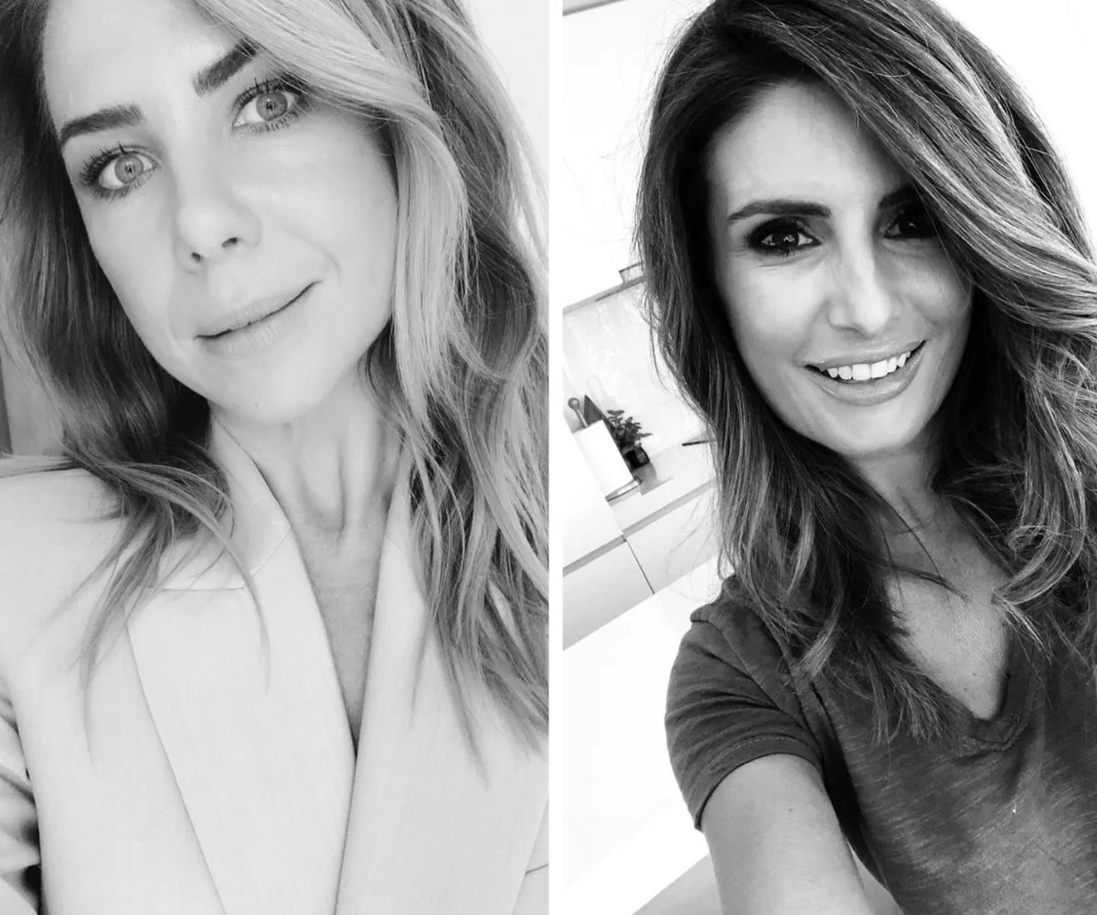 Two women in black-and-white close-up selfies, smiling gently, with long wavy hair framing their faces.