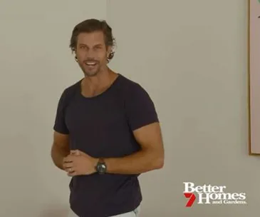 Man in a dark shirt smiling, standing indoors with "Better Homes and Gardens" logo at the bottom.