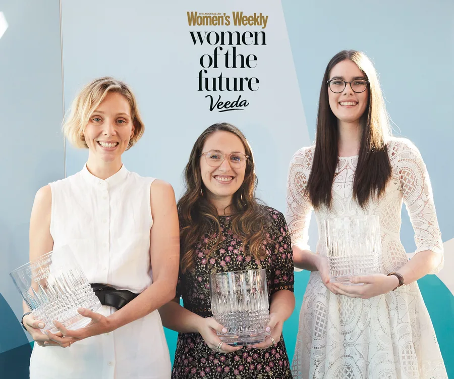 Three women smiling and holding glass awards at the Women of the Future 2020 competition event.