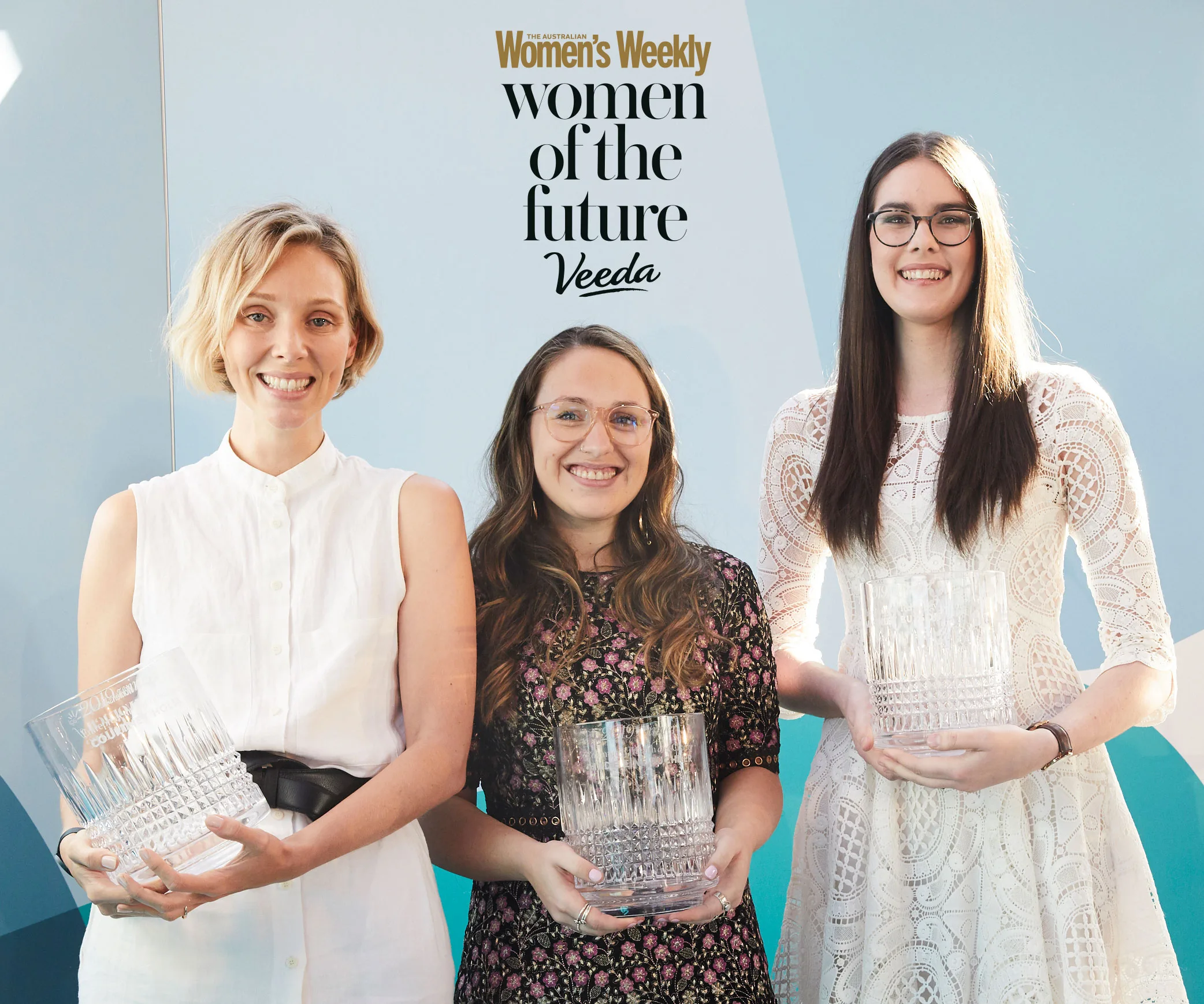 Three women smiling and holding glass awards at the Women of the Future 2020 competition event.