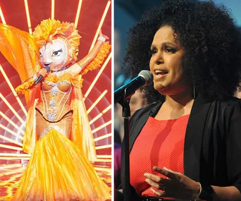 "On The Masked Singer Australia stage, a vibrant character in an elaborate orange costume next to a woman singing."