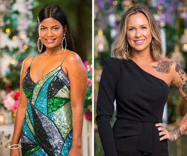 Women in glamorous dresses stand smiling; one in a multicolored gown, the other in a black one-shoulder dress with tattoos.