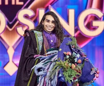 "The Masked Singer Australia 2020: Wizard character with colorful costume and props, smiling on stage."