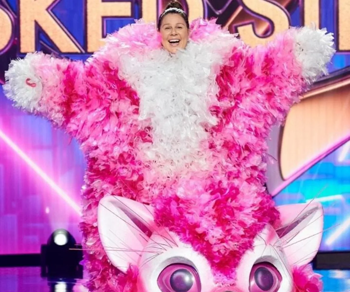 Masked Singer Australia 2020 contestant in pink kitten costume with feathered details and large cat ears on stage.