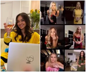 "Person in yellow with wine and laptop, video call with six women holding roses in formal attire."