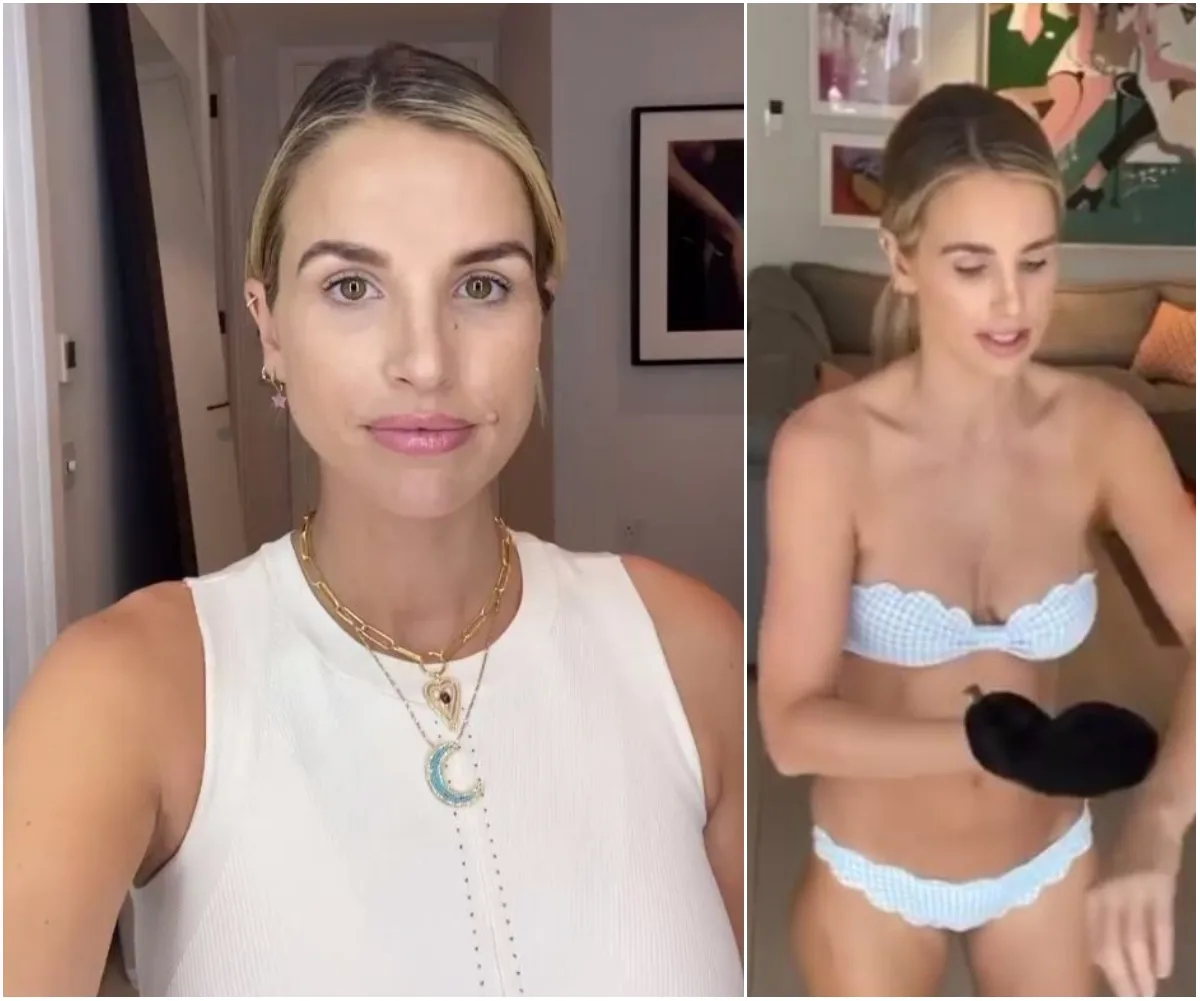 A woman in a white top and a bikini applying self-tan in a room with framed art on the wall.