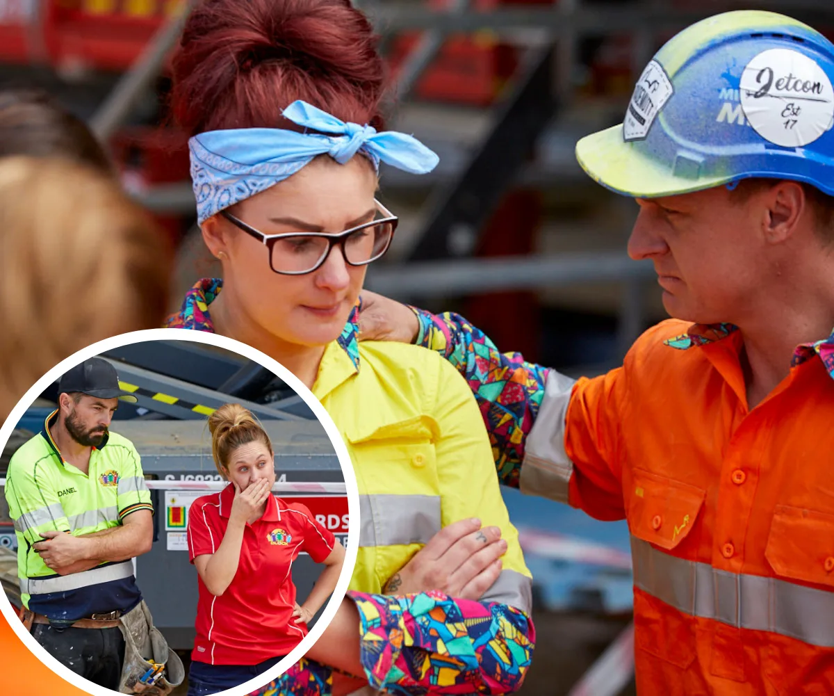Workers on a construction site show concern, one woman wiping tears, another with arms crossed. Safety gear is visible.