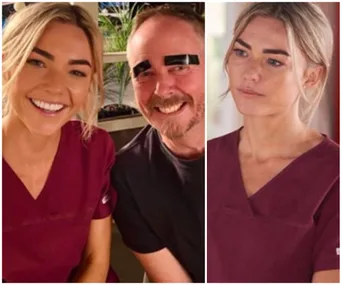 Two people smiling; one with fake black eyebrows. A woman wears maroon scrubs, possibly from a TV show set.