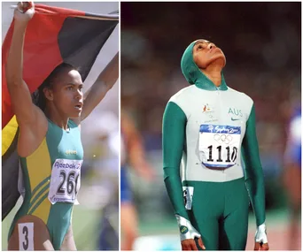 Athlete celebrates with flag and in a race suit, wearing number 1110 at Sydney 2000 Olympics.
