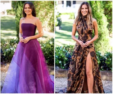 Two women in elegant dresses; one in purple strapless, the other in a patterned halter with a slit, both posed outdoors.