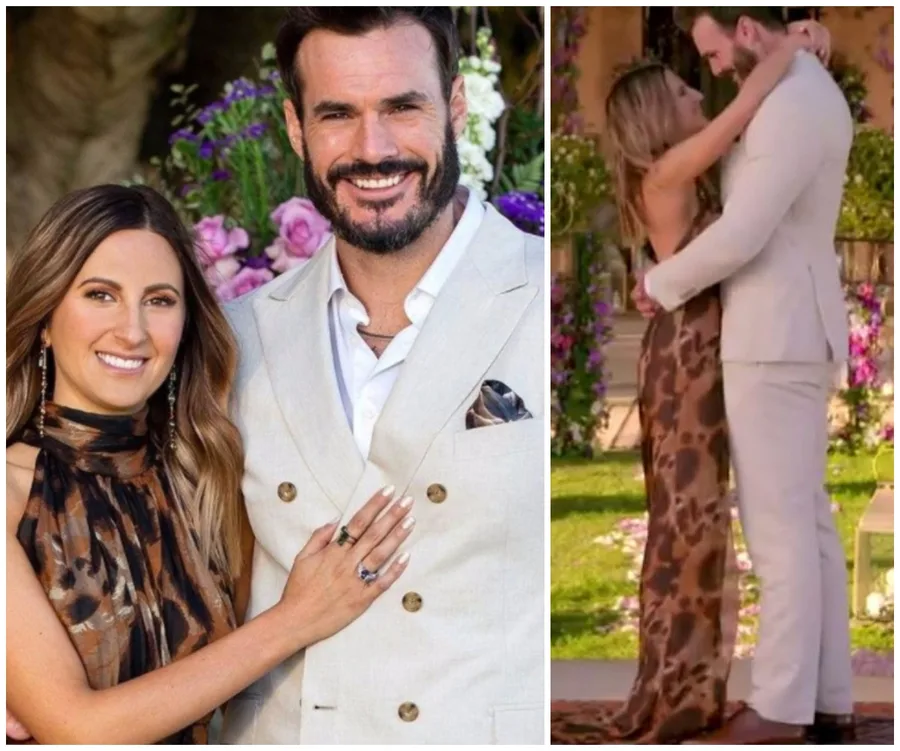 A couple embraces in a garden setting, the man in a light suit and the woman in a leopard print dress, smiling.