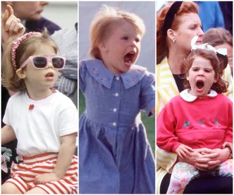 Young Princess Eugenie in sunglasses, a blue dress, and a red sweatshirt with ribbons, expressing playful joy.