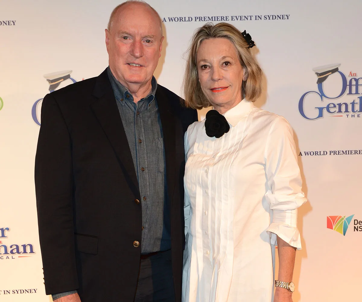 A man in a dark suit and a woman in a white dress at the premiere of "An Officer and a Gentleman" in Sydney.