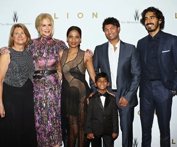 Group of six cast members from the film "Lion" posing together at a premiere event.