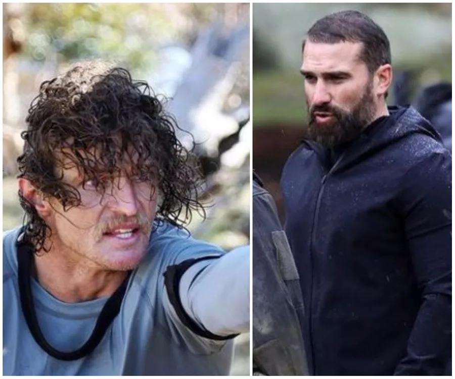 "Two men outdoors in intense discussion, one with curly wet hair, other with a beard, both in rugged outdoor gear."