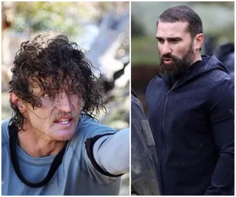 "Two men outdoors in intense discussion, one with curly wet hair, other with a beard, both in rugged outdoor gear."