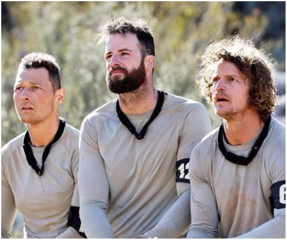 Three men in tactical gear participating in a challenge on "SAS Australia," looking focused and determined.