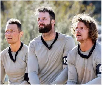 Three men in tactical gear participating in a challenge on "SAS Australia," looking focused and determined.