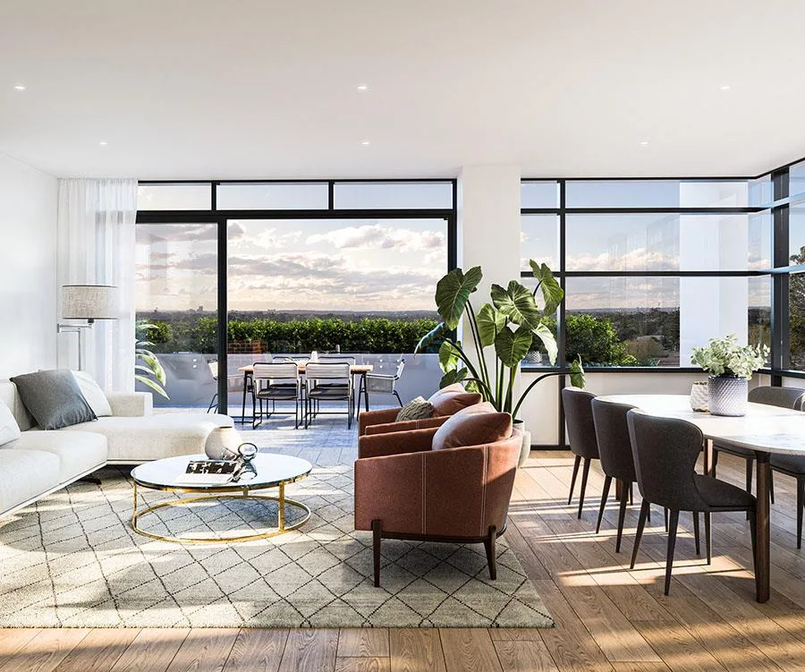 Modern living room with large windows, cozy seating, dining area, and a balcony view of greenery and sky.