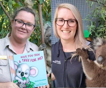 Two women holding a koala-themed book "Have You Seen a Tree For Me?" and a koala at Koala Rescue Australia.