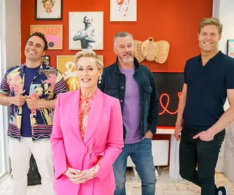 Four smiling presenters pose in a colorful, art-filled living room during a Christmas special.