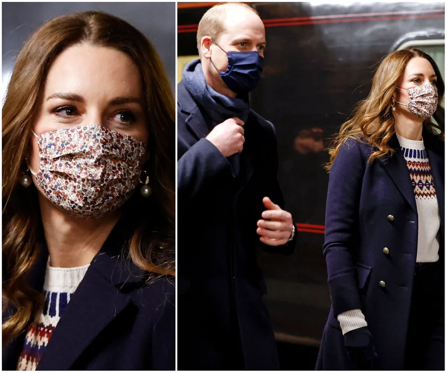 Royal couple wearing masks and dark coats during a train tour visit.