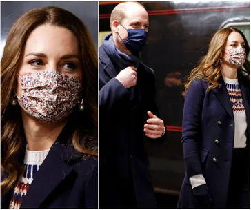 Royal couple wearing masks and dark coats during a train tour visit.