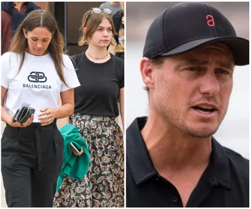 Two women walking, one in a Balenciaga shirt, next to a man in a black cap.