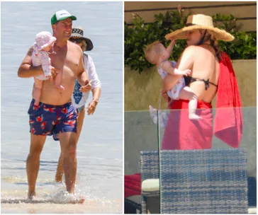 Man holding baby in ocean; woman with baby by poolside wearing sunhat, wrapped in a red towel.