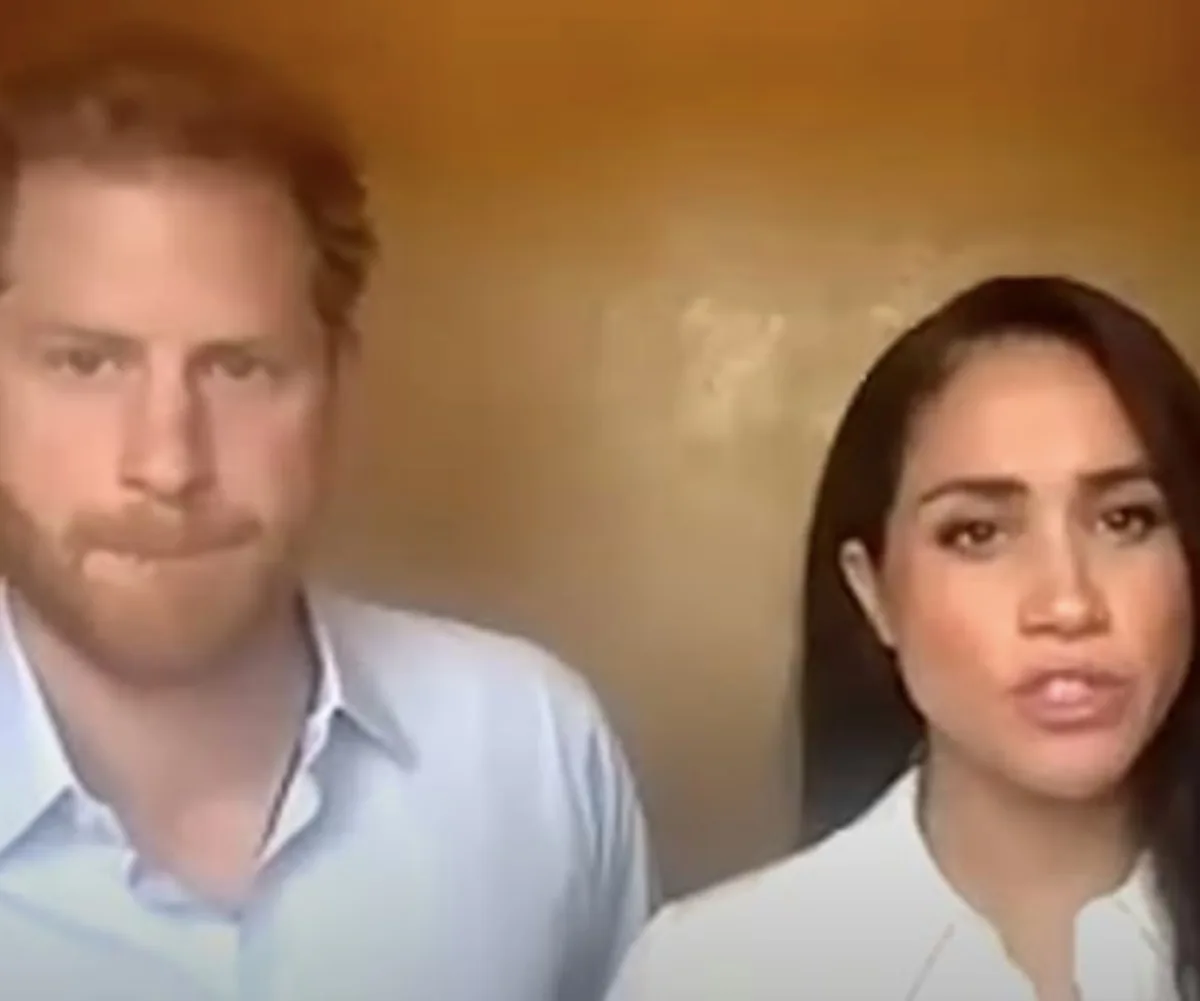Two individuals in a video call, one with red hair, wearing a light shirt, and the other with long dark hair, also in a light shirt.
