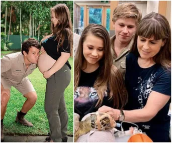 Pregnant woman at Australia Zoo with family, partner kissing belly, another family member holds a tortoise in a bandage.